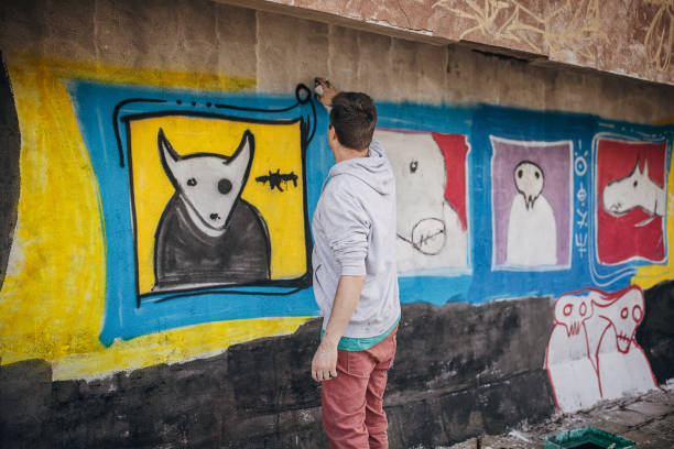 istock Artist painting graffiti on wall 1438684419