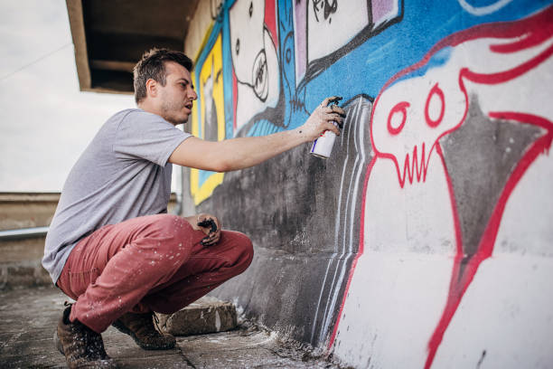 istock Male artist painting graffiti 1438686583
