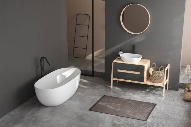istock Modern minimalist bathroom interior, modern bathroom cabinet, white sink, wooden vanity, interior plants, bathroom accessories, bathtub and shower, black and beige walls, concrete floor. 3d rendering 1438689116