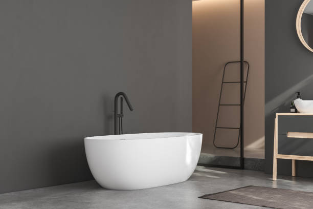 istock Modern minimalist bathroom interior, modern bathroom cabinet, white sink, wooden vanity, interior plants, bathroom accessories, bathtub and shower, black and beige walls, concrete floor. 3d rendering 1438689117