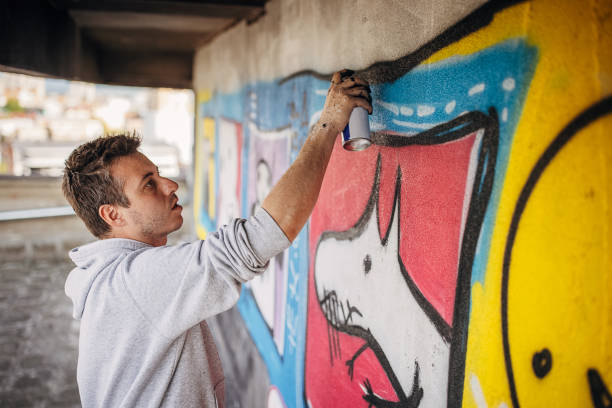 istock Male artist painting graffiti 1438689175