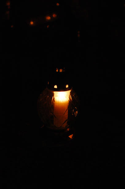 istock Votive candles burning on a cemetery. 1438690891