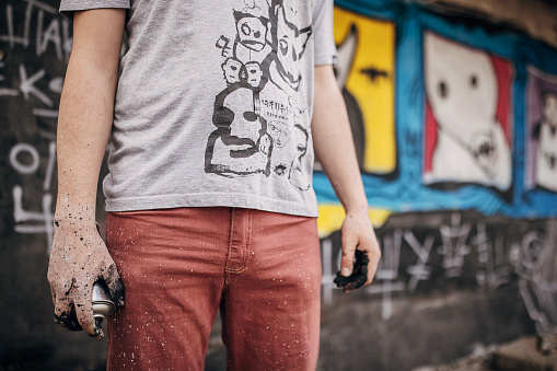 Melbourne, Australia - Sep 9, 2015: Street artist creating graffiti at Hosier Lane in Melbourne, Australia. Hosier Lane is a laneway in CBD of Melbourne, It is a popular landmark in Melbourne due to its graffitti covered walls and urban art.