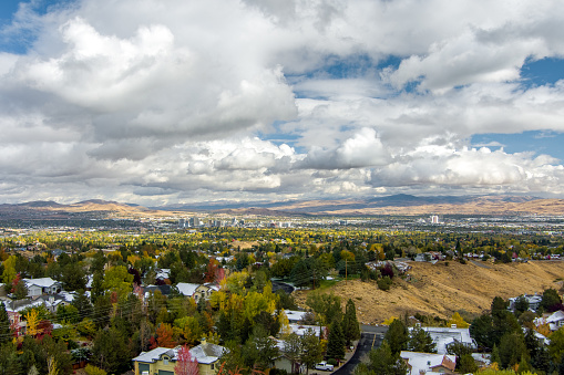 Aerial Reno landscape with a dramatic sky and brightly colored trees in late Autumn.