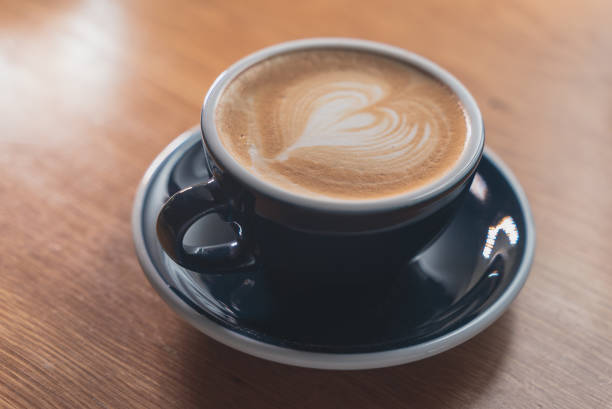 istock Blue cup of coffee on wooden table. 1438692138