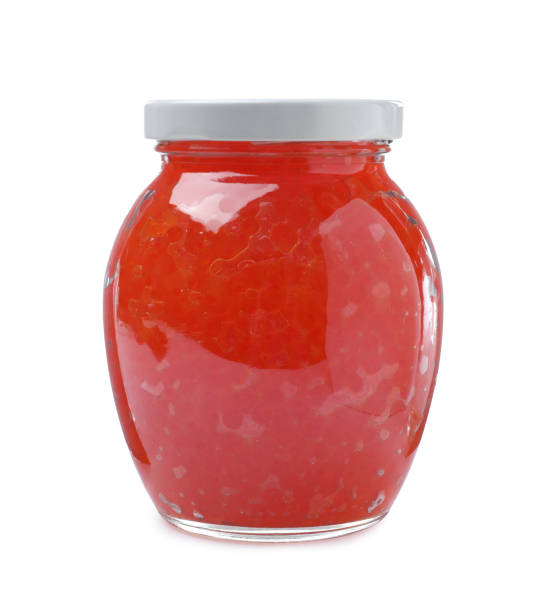 istock Glass jar with delicious red caviar isolated on white 1438693886
