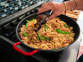 Adding soy sauce to  fried rice