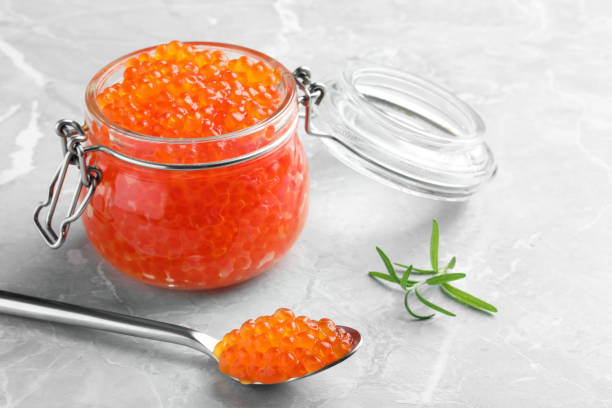 istock Delicious red caviar and rosemary on light grey table 1438696031