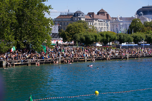 Crowd of people at lakeshore of Lake Zürich at 29th Street Parade at City of Zürich on a sunny summer day. Photo taken August 13th, 2022, Zurich, Switzerland.