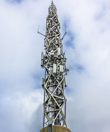 Cell phone transmitters on telecommunication tower on a cloudy  day. Shot at Potters Bar in England on 3rd November 2022.