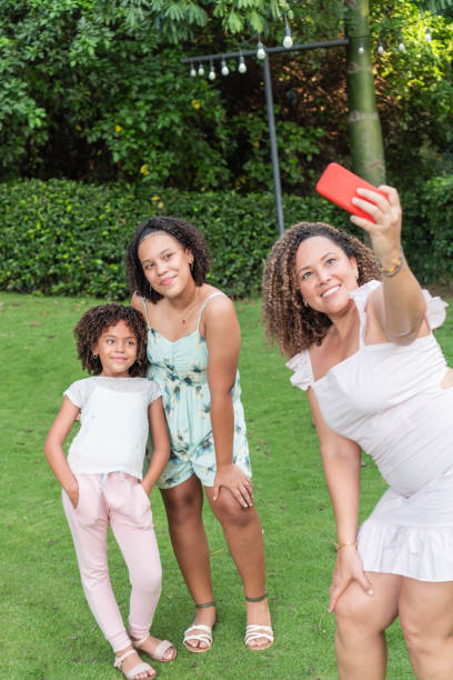 istock mother taking a selfie with her daughters outdoors 1438699891