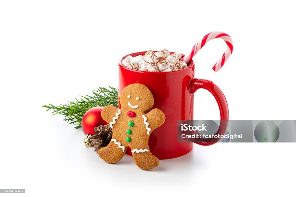Hot chocolate mug, candy cane and marshmallows on white background Close up view of a red mug filled with hot chocolate, candy cane and marshmallows isolated on white background. A gingerbread man cookie and Christmas decoration complete the composition. Copy space available. High resolution 42Mp studio digital capture taken with Sony A7rII and Sony FE 90mm f2.8 macro G OSS lens Christmas Stock Photo