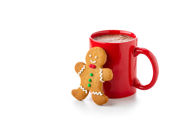 Close up view of a red mug filled with hot chocolate and gingerbread man cookie isolated on white background. Christmas decoration complete the composition. Copy space available. High resolution 42Mp studio digital capture taken with Sony A7rII and Sony FE 90mm f2.8 macro G OSS lens