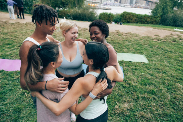 istock Young people embracing and smiling in a circle 1438702909