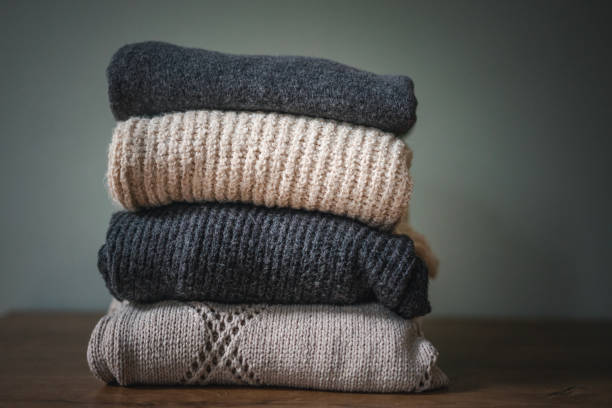 istock Stack of warm cozy sweaters in neutral gray and beige shades 1438707071