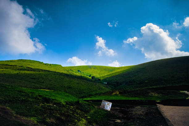 Beautiful green hills covered with cloud shadows on a sunny day.