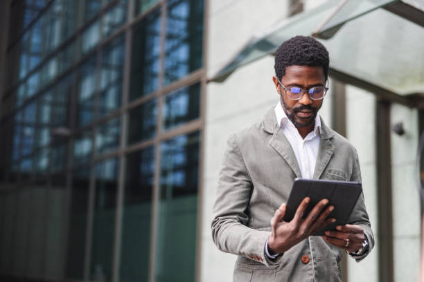 Young African American Male Entrepreneur Using Wireless Technology On A Business Trip stock photo