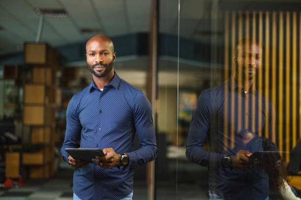 Handsome Black Male Entrepreneur Working With A Digital Tablet In A Modern Workplace