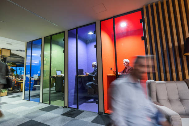 istock Businesspeople Working In Colorful Cubicles In A Creative Office 1438711083