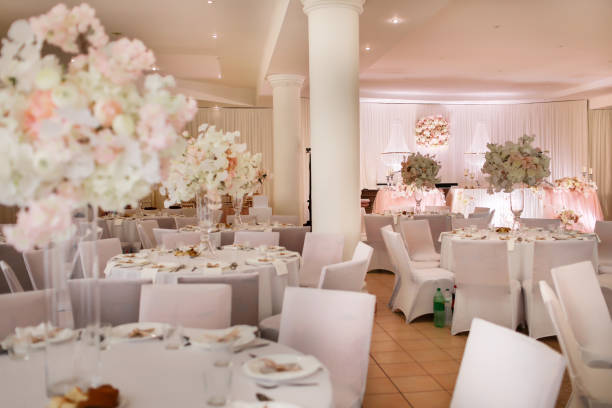 festive wedding table decoration with crystal chandeliers, golden candlesticks, candles and white pink flowers . stylish wedding day festive wedding table decoration with crystal chandeliers, golden candlesticks, candles and white pink flowers . stylish wedding day. wedding hall stock pictures, royalty-free photos & images