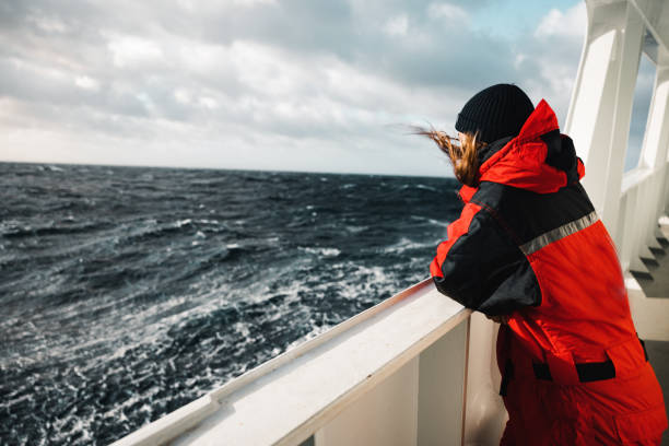 woman researcher on a fishing boat with rough sea - arctic sea imagens e fotografias de stock