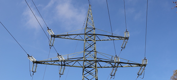 an electric high voltage pylon with blue sky
