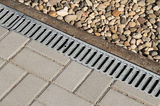 a sewage gutter on a paved place