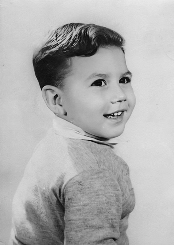 Black and white Image from the fifties, smiling little boy portrait