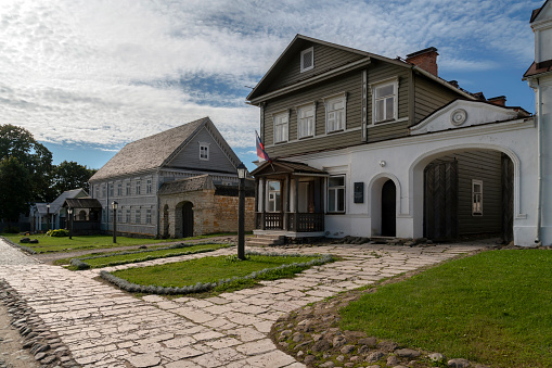 Izborsk, Pskov region, Russia, 09.03.2022: View of historical merchant buildings of estates on the main street of Izborsk Pechorskaya Street on a summer sunny day