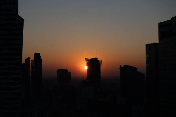 istock Modern buildings in silhouette against sunset 1438717422