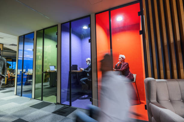 istock Mature Caucasian Office Employees Working In Colorful Cubicles 1438719743