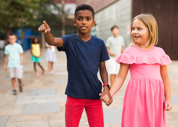 istock Boy and girl walking together hand in hand 1438719829
