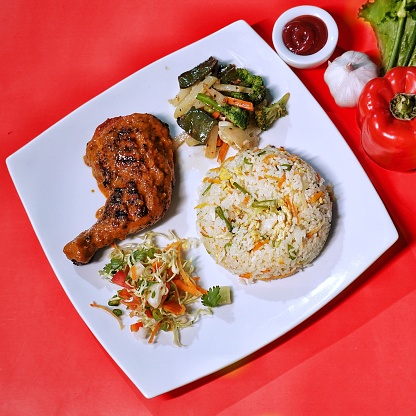 Chicken Peri Peri Platter with fried rice, salad and dip served in dish top view of fastfood