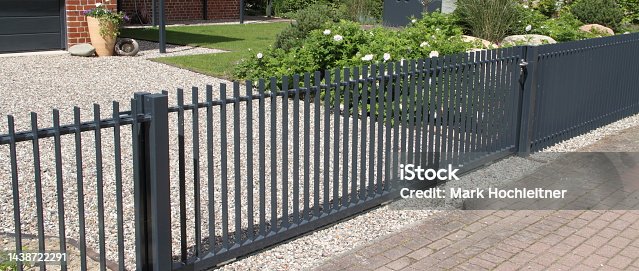 istock a driveway with a gray sliding gate 1438722291