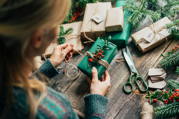 istock Unrecognizable woman decorating Christmas gifts 1438722977