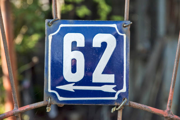 istock Weathered enameled plate number 62 1438724279