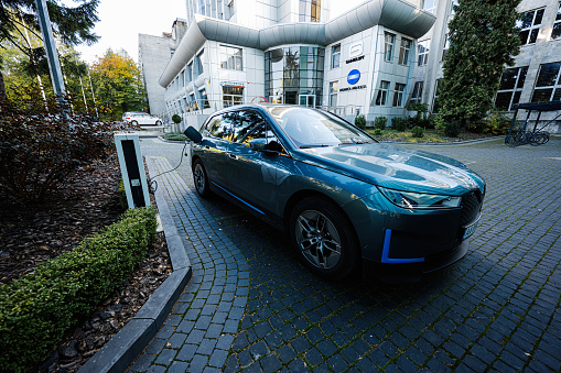 Lviv, Ukraine - October 09, 2022: BMW iX on charging station. Car is a battery electric mid size luxury crossover SUV.