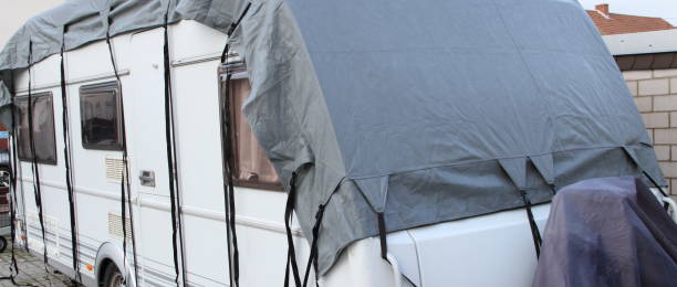 istock a caravan with a gray tarpaulin 1438725451