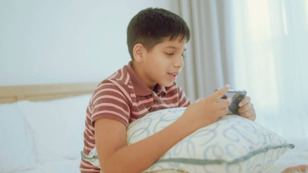 istock A young Indian enjoying smartphone games at home. 1438725814