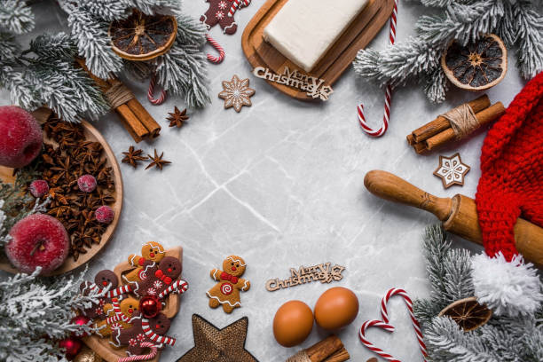 istock Happy New Year 2023. Banner with kitchen utensils, Christmas decorations, cinnamon, gingerbread and spruce on a marble background. A greeting card for Christmas. The concept of cafes and restaurants. 1438727145