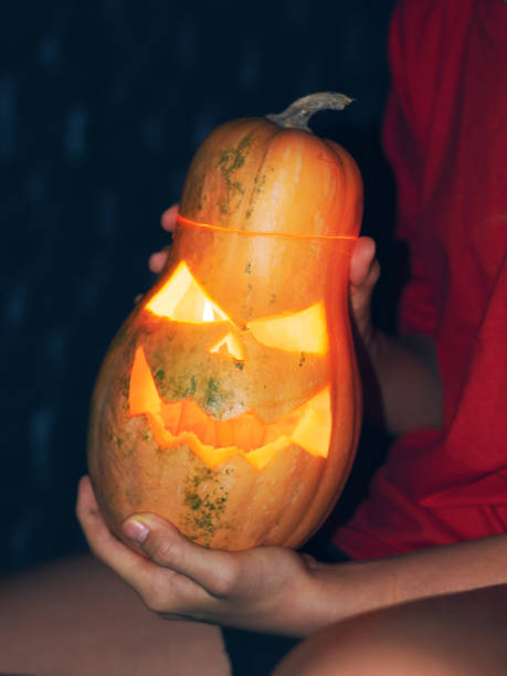 istock He holds a Halloween pumpkin in his hands. 1438727300