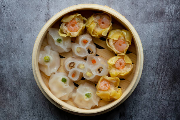istock Dim Sum mix steamed in bamboo  wood basket. 1438728413