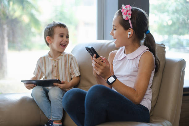 istock Children of different age group using smartphone and computer equipments together 1438729349