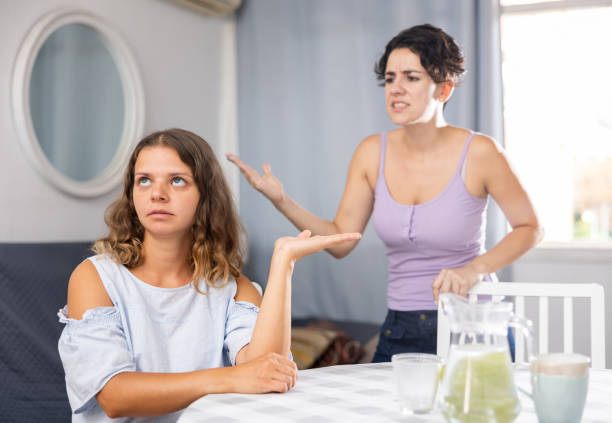 istock Irritated relationships between lesbians. Emotional woman screaming behind 1438731214