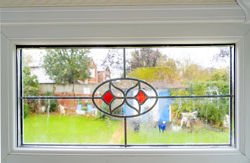 Blown double glazed window with condensation between the glass panes.