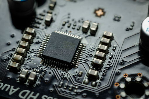 close up of the circuit board with computer chips and semiconductors