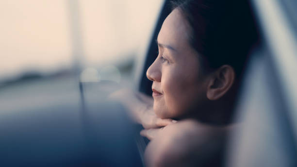 istock Asian woman enjoying watching the sunset 1438741275