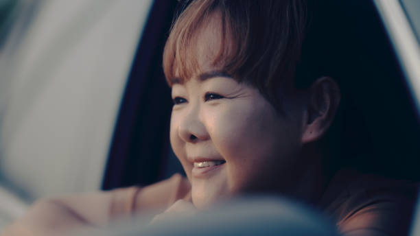 istock Asian woman enjoying watching the sunset 1438741332