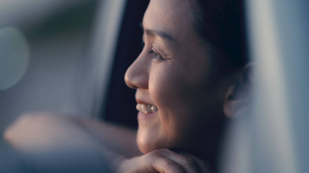 istock Asian woman enjoying watching the sunset 1438741535