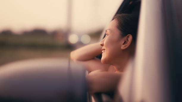 istock Asian woman enjoying watching the sunset 1438741584